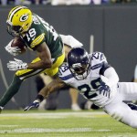 FILE - In this Sept. 20, 2015 file photo, Green Bay Packers' Randall Cobb tries to get past Seattle Seahawks' Earl Thomas (29) during the first half of an NFL football game in Green Bay, Wis.  The Packers' 27-17 win over the Seahawks snapped a three-game losing streak to Seattle, all on the road.  None of those games were more painful than the 28-22 loss in overtime in the playoffs in January after the Packers blew a 16-0 halftime lead. (AP Photo/Jeffrey Phelps)