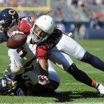 Arizona Cardinals wide receiver Larry Fitzgerald (11) dives for a touchdown past Chicago Bears cornerback Terrance Mitchell, bottom, and safety Antrel Rolle (26) during the second half of an NFL football game, Sunday, Sept. 20, 2015, in Chicago. The Cardinals won 48-23. (AP Photo/David Banks)