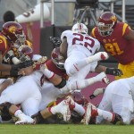 Stanford running back Remound Wright, center, scores a touchdown under pressure from Southern California linebacker Uchenna Nwosu, left, and defensive tackle Noah Jefferson, right, during the first half of an NCAA college football game, Saturday, Sept. 19, 2015, in Los Angeles. (AP Photo/Mark J. Terrill)