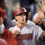 Arizona Diamondbacks' Nick Ahmed is congratulated by teammates after scoring on a ground out by A.J. Pollock during the fourth inning of a baseball game against the Los Angeles Dodgers, Tuesday, Sept. 22, 2015, in Los Angeles. (AP Photo/Mark J. Terrill)