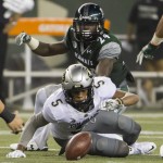 Colorado wide receiver Shay Fields (5) fumbles a punt reception as Hawaii defensive back Jamal Mayo (24) looks on in the second quarter of an NCAA college football game, Thursday, Sept. 3, 2015, in Honolulu. Hawaii recovered the fumble on the play. (AP Photo/Eugene Tanner)