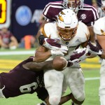 Arizona State running back Demario Richard, front, fumbles the ball as he is hit by the Texas A&M defense in the second half of an NCAA college football game on Saturday, Sept. 5, 2015, in Houston. Texas A&M recovered the fumble. (AP Photo/George Bridges)