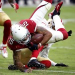 Arizona Cardinals wide receiver Michael Floyd (15) is tackled by San Francisco 49ers cornerback Kenneth Acker during the first half of an NFL football game, Sunday, Sept. 27, 2015, in Glendale, Ariz.  (AP Photo/Ross D. Franklin)