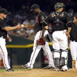 Arizona Diamondbacks starting pitcher Rubby De La Rosa (12) is pulled from the game from Arizona Diamondbacks manager Chip Hale, left, as Welington Castillo (7)  and Nick Ahmed look on during the third inning of a baseball game against the Los Angeles Dodgers, Saturday, Sept. 12, 2015, in Phoenix. (AP Photo/Matt York)