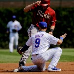 Arizona Diamondbacks' A.J. Pollock, top, is tagged out by Chicago Cubs second baseman Javier Baez on a steal-attempt during the first inning of a baseball game on Sunday, Sept. 6, 2015, in Chicago. (AP Photo/Matt Marton)