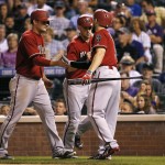 Arizona Diamondbacks' Ender Inciarte (5) greets Phil Gosselin and Chris Owings after scoring on a Aaron Hill two run double during the seventh inning of the second game of a baseball doubleheader Tuesday, Sept. 1, 2015, in Denver. (AP Photo/Jack Dempsey)