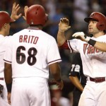 Arizona Diamondbacks A.J. Pollock, right, celebrates with Nick Ahmed and Socrates Brito after hitting a three-run home run against the San Diego Padres during the seventh inning of a baseball game, Tuesday, Sept. 15, 2015, in Phoenix. (AP Photo/Rick Scuteri)