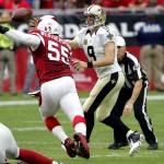 New Orleans Saints quarterback Drew Brees (9) throws under pressure from Arizona Cardinals linebacker Sean Weatherspoon (55) during the first half of an NFL football game, Sunday, Sept. 13, 2015, in Glendale, Ariz. (AP Photo/Ross D. Franklin)