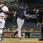 San Diego Padres' Wil Myers, middle, crosses home plate after hitting a home run as Arizona Diamondbacks' Welington Castillo, left, and umpire Bruce Dreckman, right, watch during the first inning of a baseball game, Monday, Sept. 14, 2015, in Phoenix. (AP Photo/Ross D. Franklin)