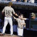 San Diego Padres' Travis Jankowski (16) gets congratulations from interim manager Pat Murphy, right, and teammates after scoring on a single by Cory Spangenberg during the fifth inning of a baseball game against the Arizona Diamondbacks in San Diego, Sunday, Sept. 27, 2015. (AP Photo/Alex Gallardo)