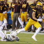 Arizona State's D.J. Foster (8) gets past Cal Poly's Chris Fletcher (21) during the first half of an NCAA college football game Saturday, Sept. 12, 2015, in Tempe, Ariz. (AP Photo/Ross D. Franklin)
