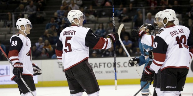 Arizona Coyotes' Connor Murphy (5) celebrates after assisting on a goal by Antoine Vermette, obscur...
