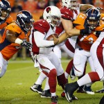 Arizona Cardinals quarterback Phillip Sims (1) is hit by Denver Broncos middle linebacker Lamin Barrow (57) during the first half of an NFL preseason football game, Thursday, Sept. 3, 2015, in Denver. (AP Photo/Jack Dempsey)