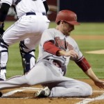 Arizona Diamondbacks' Phil Gosselin, below, scores off a single by A.J. Pollock as San Diego Padres catcher Derek Norris, above, awaits the throw during the first inning of a baseball game Friday, Sept. 25, 2015, in San Diego. (AP Photo/Gregory Bull)