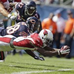 Arizona Cardinals wide receiver Jaron Brown (13) dives to the end zone for a touchdown past Chicago Bears safety Adrian Amos (38) during the first half of an NFL football game Sunday, Sept. 20, 2015, in Chicago. (AP Photo/Michael Conroy)