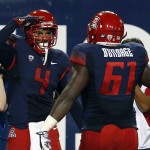 Arizona wide receiver David Richards (4) celebrates with Cayman Bundage after scoring a touchdown against UTSA during the first half of an NCAA college football game, Thursday, Sept. 3, 2015, in Tucson, Ariz. (AP Photo/Rick Scuteri)