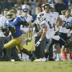UCLA linebacker Myles Jack runs with the ball after intercepting the ball while BYU wide receiver Mitchell Juergens runs after him late in the fourth quarter of an NCAA college football game, Saturday, Sept. 19, 2015, in Pasadena, Calif. UCLA won 24-23. (AP Photo/Danny Moloshok)