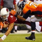 Arizona Cardinals quarterback Logan Thomas (6) dives for yards as Denver Broncos defensive end Josh Watson (70) and Zaire Anderson (47) defend during the second half of an NFL preseason football game, Thursday, Sept. 3, 2015, in Denver. (AP Photo/Jack Dempsey)