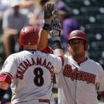 Arizona Diamondbacks' Jarrod Saltalamacchia is congratulated by teammate Yasmany Tomas after hitting a home run off Colorado Rockies relief pitcher Yohan Flande during the second inning in the first game of a baseball doubleheader, Tuesday, Sept. 1, 2015, in Denver. (AP Photo/Jack Dempsey)