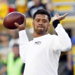 Seattle Seahawks quarterback Russell Wilson warms up before an NFL football game against the Green Bay Packers Sunday, Sept. 20, 2015, in Green Bay, Wis. (AP Photo/Mike Roemer)