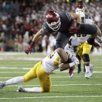 Washington State wide receiver River Cracraft, top, dives as Wyoming cornerback Antonio Hull (21) brings him down during the second half of an NCAA college football game, Saturday, Sept. 19, 2015, in Pullman, Wash. Washington State won 31-14. (AP Photo/Young Kwak)