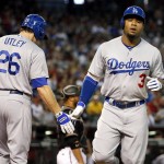 Los Angeles Dodgers' Carl Crawford (3) is greeted by teammate Chase Utley after hitting a solo home run against the Arizona Diamondbacks during the first inning of a baseball game, Saturday, Sept. 12, 2015, in Phoenix. (AP Photo/Matt York)