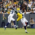 Seattle Seahawks' Richard Sherman (25) is called for pass interference on this pass to Green Bay Packers' James Jones during the first half of an NFL football game Sunday, Sept. 20, 2015, in Green Bay, Wis. Also pictured is Earl Thomas (29). (AP Photo/Mike Roemer)