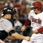 Arizona Diamondbacks Phil Gosselin, right, scores on a sacrifice fly out on a ball hit by A.J. Pollock in the fourth inning during a baseball game against the San Francisco Giants, Monday, Sept. 7, 2015, in Phoenix. (AP Photo/Rick Scuteri)