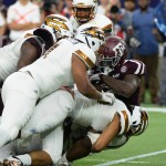 Texas A&M running back Tra Carson (5) is wrapped up by the Arizona State defense in the first half of their NCAA college football game on Saturday, Sept. 5, 2015, in Houston. (AP Photo/George Bridges)