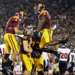 Southern California's Taylor McNamara (48) celebrates his pass reception touchdown with quarterback Cody Kessler (6), wide receiver JuJu Smith-Schuster (9) and guard Toa Lobendahn, rear right, during the first half of an NCAA college football game against Arkansas State, Saturday, Sept. 5, 2015, in Los Angeles. (AP Photo/Danny Moloshok)
