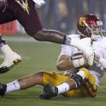 Southern California's Cody Kessler sits on the ground after recovering a bad snap that went over his head during the first half of an NCAA college football game against Arizona State on Saturday, Sept. 26, 2015, in Tempe, Ariz. (AP Photo/Ross D. Franklin)