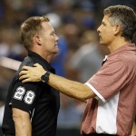 Umpire Jim Wolf (28) gets examined by Arizona Diamondbacks trainer Ken Crenshaw after getting hit with a foul ball during the second inning of the Diamondbacks' baseball game against the Los Angeles Dodgers, Friday, Sept. 11, 2015, in Phoenix. (AP Photo/Rick Scuteri)