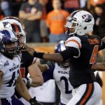 Oregon State quarterback Seth Collins, right, throws as Weber State defensive lineman Jonathan Carlson watches during the second half of an NCAA college football in Corvallis, Ore., Friday, Sept. 4, 2015. Oregon State won 26-7. (AP Photo/Don Ryan)