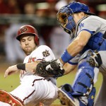 Arizona Diamondbacks' Chris Owings, left, gets tagged out by Los Angeles Dodgers catcher A.J. Ellis on a ball hit by Yasmany Tomas during the first inning of a baseball game, Friday, Sept. 11, 2015, in Phoenix. (AP Photo/Rick Scuteri)