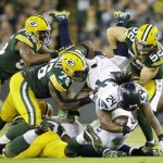 Seattle Seahawks' Marshawn Lynch is stopped by Green Bay Packers' Clay Matthews (52), Mike Daniels (76) and Andy Mulumba (55) during the first half of an NFL football game Sunday, Sept. 20, 2015, in Green Bay, Wis. (AP Photo/Jeffrey Phelps)