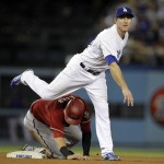 Los Angeles Dodgers second baseman Chase Utley makes the relay to first over Arizona Diamondbacks' Jake Lamb to get Brandon Drury at first for a double play during the fifth inning of a baseball game in Los Angeles, Wednesday, Sept. 23, 2015. (AP Photo/Alex Gallardo)