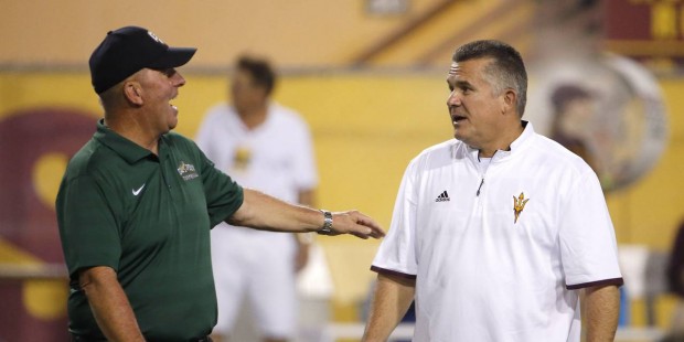 Arizona State coach Todd Graham, right, talks with Cal Poly coach Tim Walsh prior to an NCAA colleg...