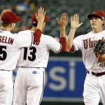 Arizona Diamondbacks' Peter O'Brien, right, celebrates with Nick Ahmed (13) and Phil Gosselin (15) after the Diamondbacks defeated the Los Angeles Dodgers 12-4 during a baseball game, Friday, Sept. 11, 2015, in Phoenix. (AP Photo/Rick Scuteri)