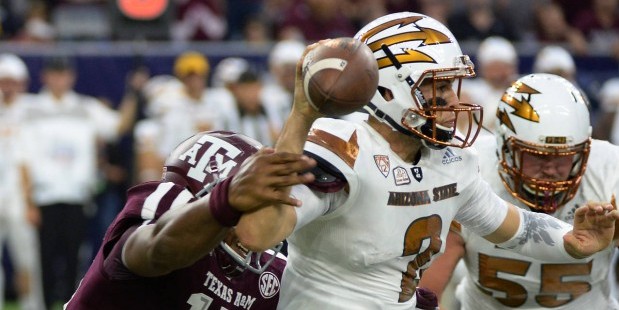 Arizona State quarterback Mike Bercovici (2) is pressured as he passes by Texas A&M defensive linem...