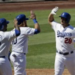 Los Angeles Dodgers' Chris Heisey, right, celebrates after a grand slam home run with Howie Kendrick, left, and Justin Turner during the fifth inning of a baseball game against the Arizona Diamondbacks in Los Angeles, Thursday, Sept. 24, 2015. (AP Photo/Chris Carlson)