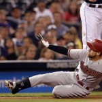 Arizona Diamondbacks' Ender Inciarte, below, slides into third with a triple to left field as San Diego Padres third baseman Cory Spangenberg leaps to catch the throw during the sixth inning of a baseball game in San Diego, Saturday, Sept. 26, 2015. (AP Photo/Alex Gallardo)