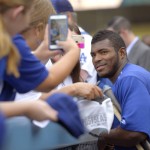 Los Angeles Dodgers' Yasiel Puig poses for photos with fans prior to a baseball game against the Arizona Diamondbacks, Monday, Sept. 21, 2015, in Los Angeles. (AP Photo/Mark J. Terrill)