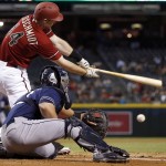 Arizona Diamondbacks' Paul Goldschmidt, top, strikes out as San Diego Padres' Austin Hedges reaches out for the baseball during the first inning of a baseball game Wednesday, Sept. 16, 2015, in Phoenix. (AP Photo/Ross D. Franklin)