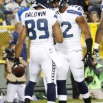 Seattle Seahawks' Doug Baldwin (89) celebrates his touchdown catch with Fred Jackson during the second half of an NFL football game against the Green Bay Packers Sunday, Sept. 20, 2015, in Green Bay, Wis. (AP Photo/Mike Roemer)