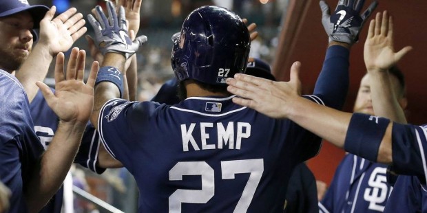 San Diego Padres' Matt Kemp gets high-fives from teammates in the dugout after his three-run home r...