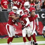 Arizona Cardinals cornerback Justin Bethel (28) celebrates his interception for a touchdown with Tyrann Mathieu (32) and Calais Campbell (93) against the San Francisco 49ers during the first half of an NFL football game, Sunday, Sept. 27, 2015, in Glendale, Ariz.  (AP Photo/Ross D. Franklin)