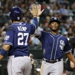 San Diego Padres' Matt Kemp (27) and Justin Upton, right, celebrate after both scored run against the Arizona Diamondbacks during the fifth inning of a baseball game Monday, Sept. 14, 2015, in Phoenix. (AP Photo/Ross D. Franklin)