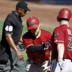 Arizona Diamondbacks' Aaron Hill, right, congratulates Ender Inciarte for hitting a solo home run, with home plate umpire Anthony Johnson, left, looking away, during the fifth inning of a baseball game against the San Diego Padres in San Diego, Sunday, Sept. 27, 2015. (AP Photo/Alex Gallardo)