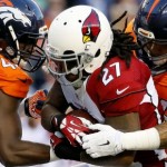 Arizona Cardinals running back Chris Johnson (27) his tackled by Denver Broncos linebacker Shane Ray (56) and linebacker Shaquil Barrett (48) during the first half of an NFL preseason football game, Thursday, Sept. 3, 2015, in Denver. (AP Photo/Jack Dempsey)
