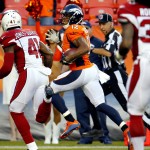 Denver Broncos wide receiver Andre Caldwell (12) scores a touchdown as Arizona Cardinals safety Harold Jones-Quartey (41) pursues during the first half of an NFL preseason football game, Thursday, Sept. 3, 2015, in Denver. (AP Photo/Jack Dempsey)